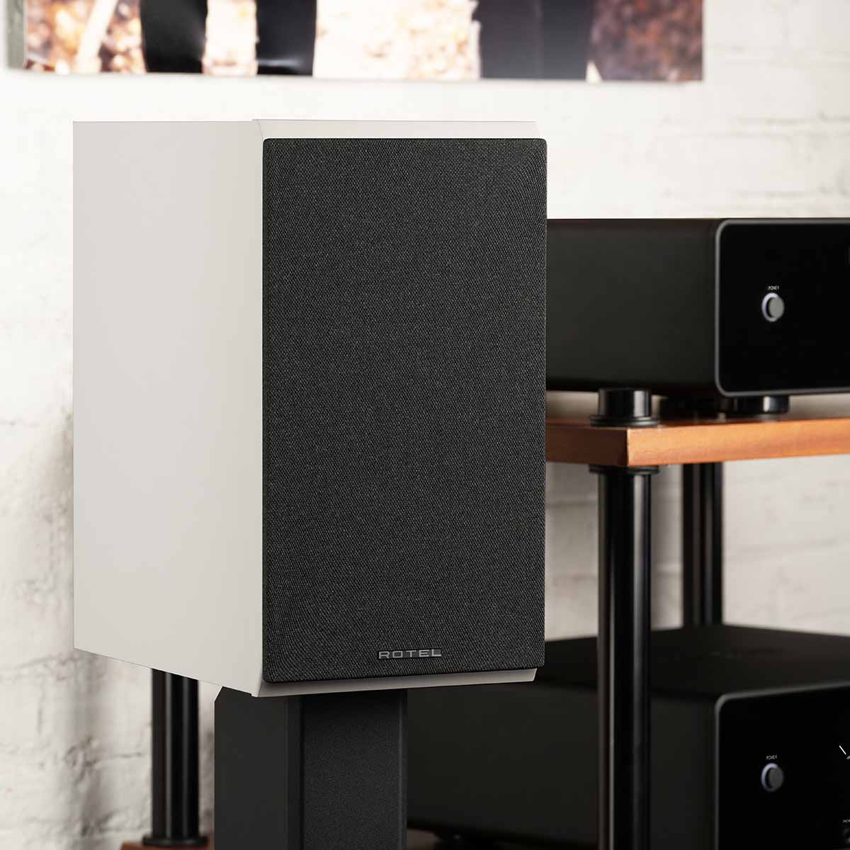 Rotel Amora 5 Passive Bookshelf Loudspeakers - Black - Lifestyle photo front and side view angled right with grille