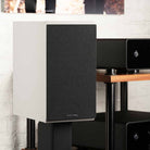 Rotel Amora 5 Passive Bookshelf Loudspeakers - Black - Lifestyle photo front and side view angled right with grille