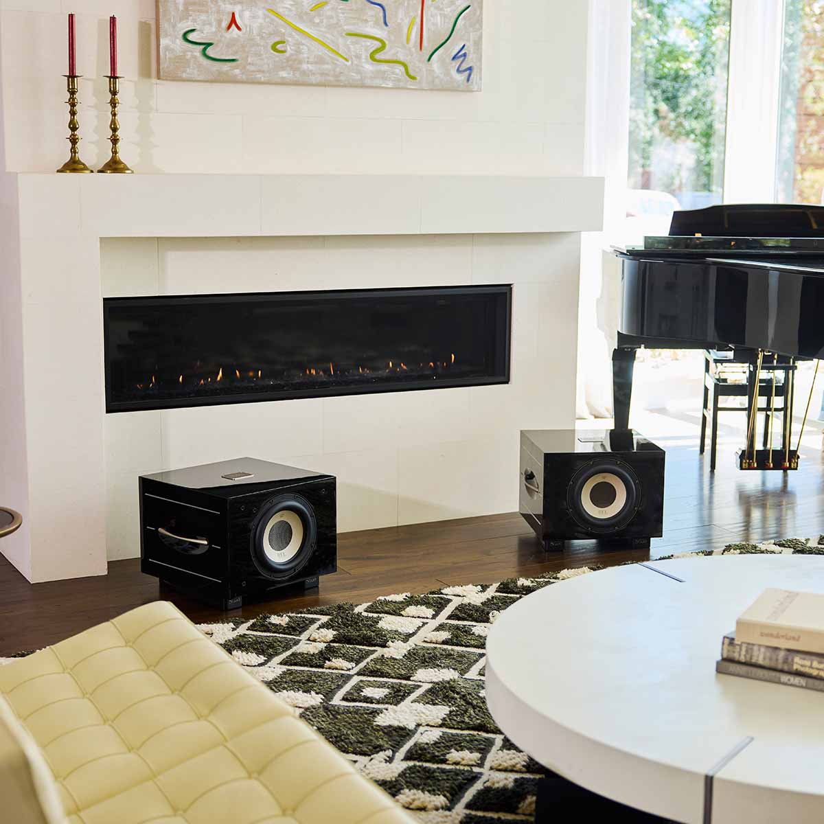 REL Acoustics S/550 Subwoofer - black - lifestyle photo two subwoofers to either side of fireplace without grilles