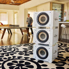 REL Acoustics S/850 Subwoofer - white - lifestyle photo of stack of three subwoofers in house without grilles