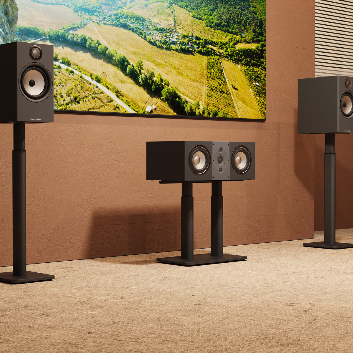 Home theater setup with speakers and a TV displaying a scenic landscape.