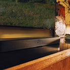 Sonos Beam Ultra Soundbar - lifestyle photo closeup of black soundbar on a cabinet in a living room