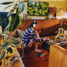 Sonos Ace Ultra Wireless Over-Ear Headphones - lifestyle photo of a woman wearing white headphones while painting her toenails