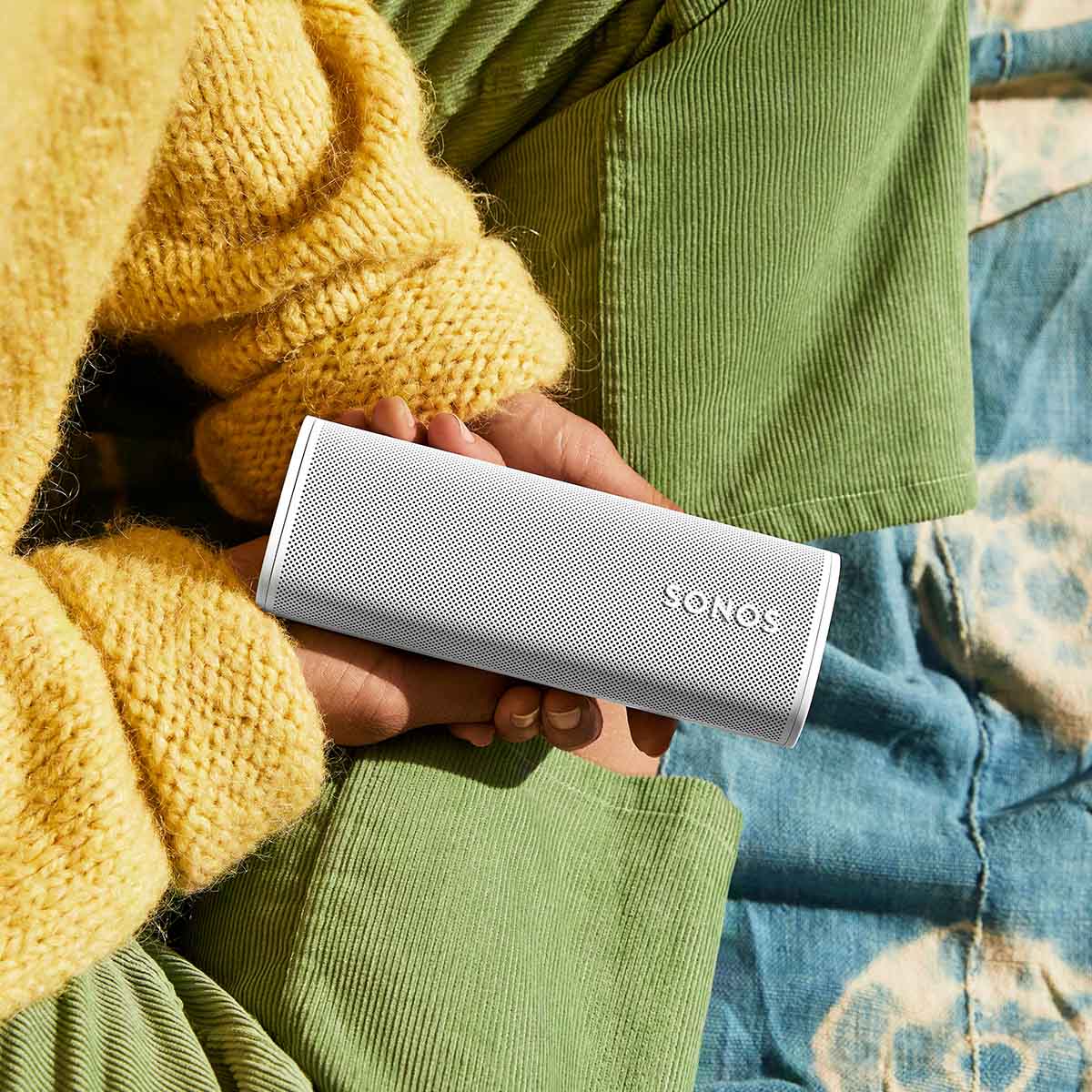 Sonos Roam 2 Portable Waterproof Smart Speaker - white - lifestyle photo person holding speaker
