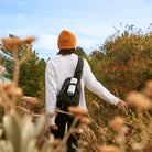 Sonos Roam 2 Portable Waterproof Smart Speaker - white - lifestyle photo person with speaker strapped to backpack