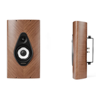 A Sonus Faber Olympica G3 W On-Wall Speaker  shown from the front and side angles against a solid white background. The speaker features a warm brown wood-grain finish with a black and white waveguide driver design on the front.