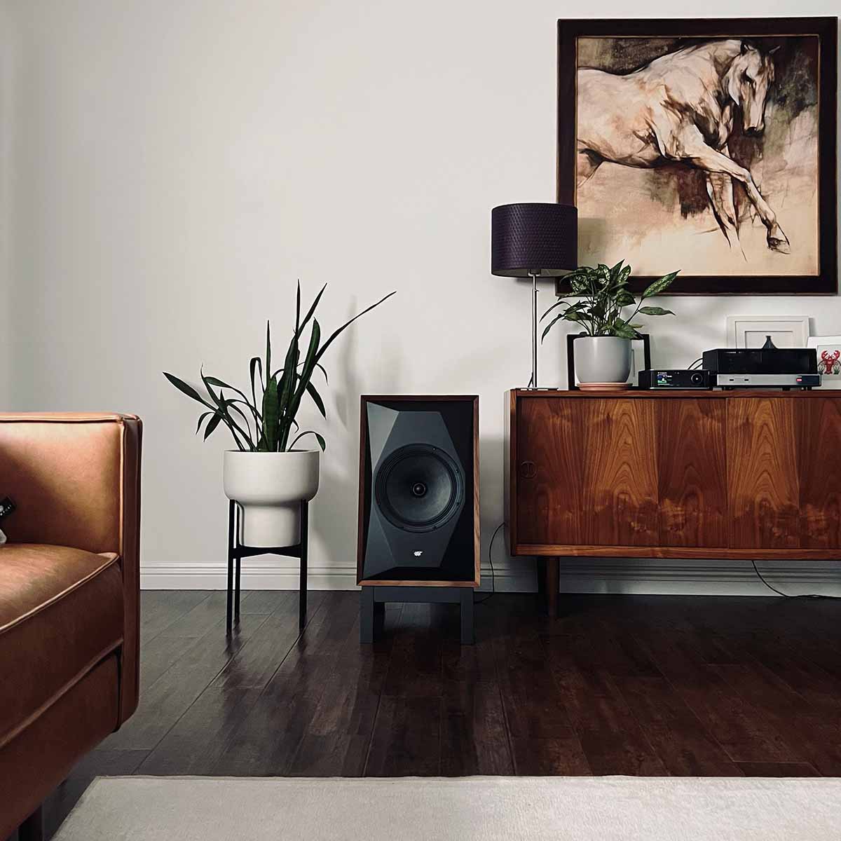 MoFi Electronics SourcePoint 10 Master Edition Bookshelf Speakers - walnut - lifestyle photo single speaker on stand next to cabinet
