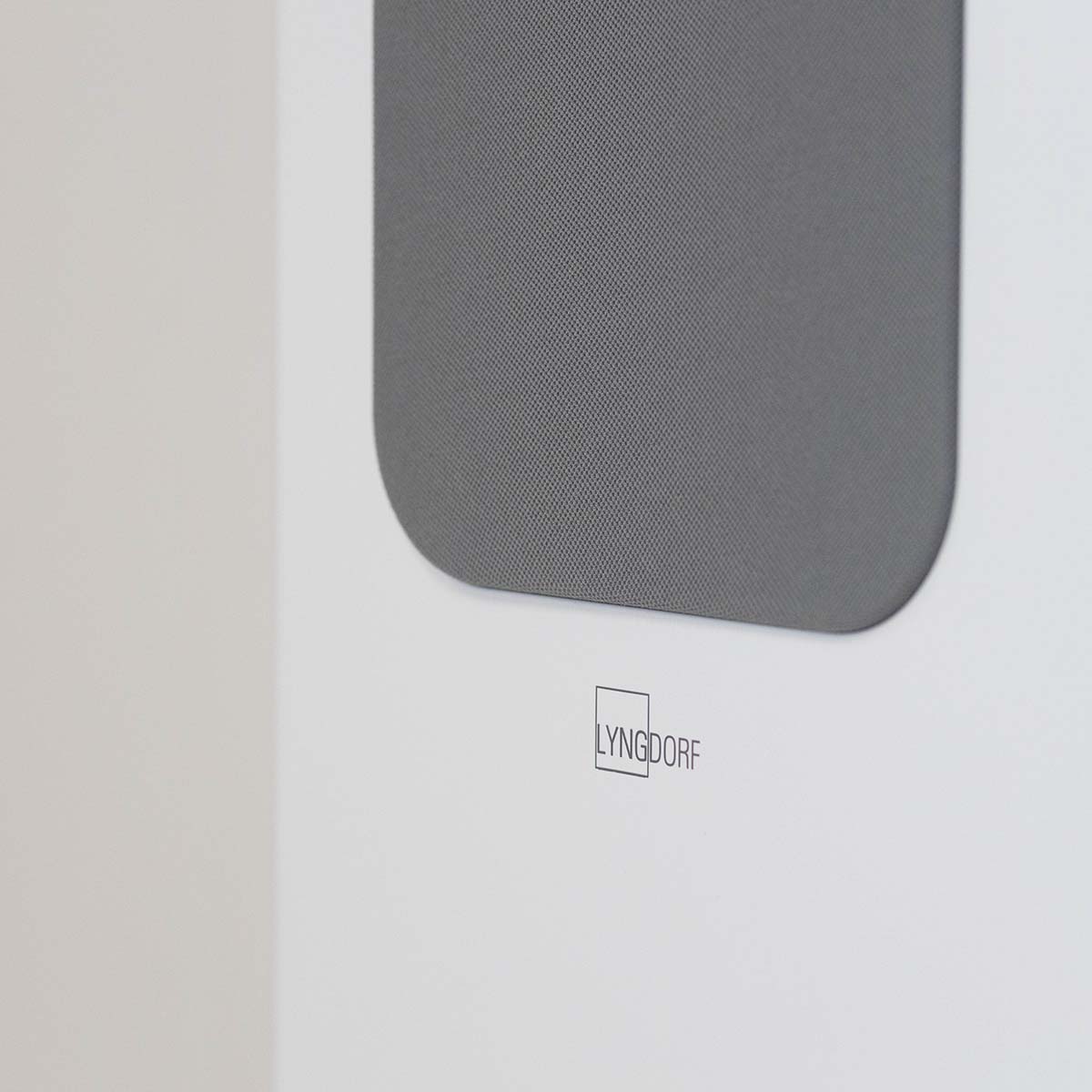 Lyngdorf FR-2 Speaker - closeup of Lyngdorf logo on white speaker with light grey grille