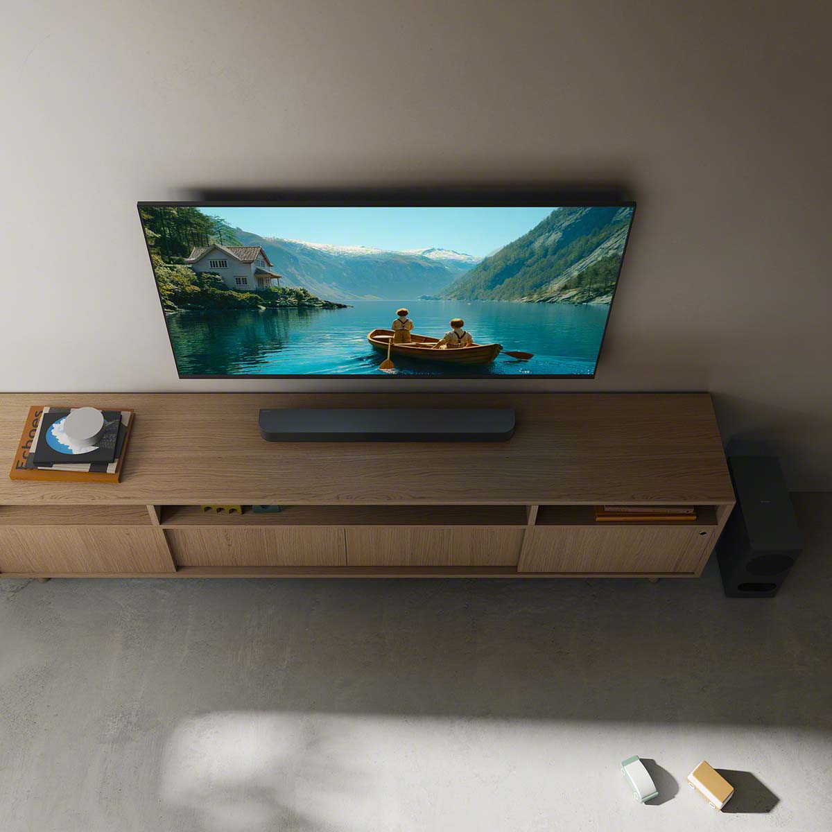 Sony BRAVIA Theater Bar 5 Soundbar lifestyle view of bar on cabinet under TV and subwoofer to right on floor