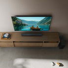 Sony BRAVIA Theater Bar 5 Soundbar lifestyle view of bar on cabinet under TV and subwoofer to right on floor
