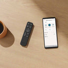 Sony BRAVIA Theater Bar 5 Soundbar remote on table to left of smartphone showing Bravia App