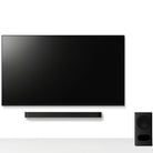 Sony BRAVIA Theater Bar 5 Soundbar front view of bar mounted under a TV with subwoofer on floor to right