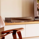 Naim Mu-so beside a tv on a console table