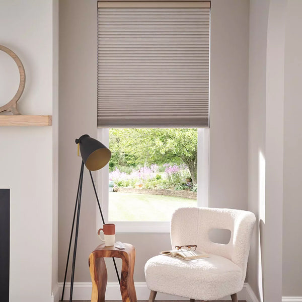 Modern interior with a window, chair, and lamp in a well-lit room.