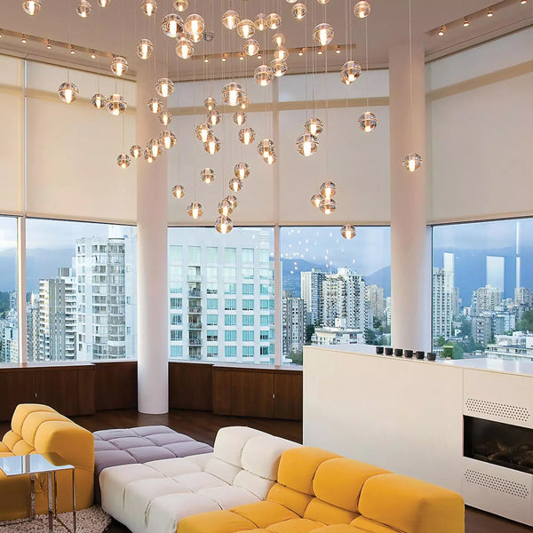 Modern living room with sofas and large windows with motorized shades.