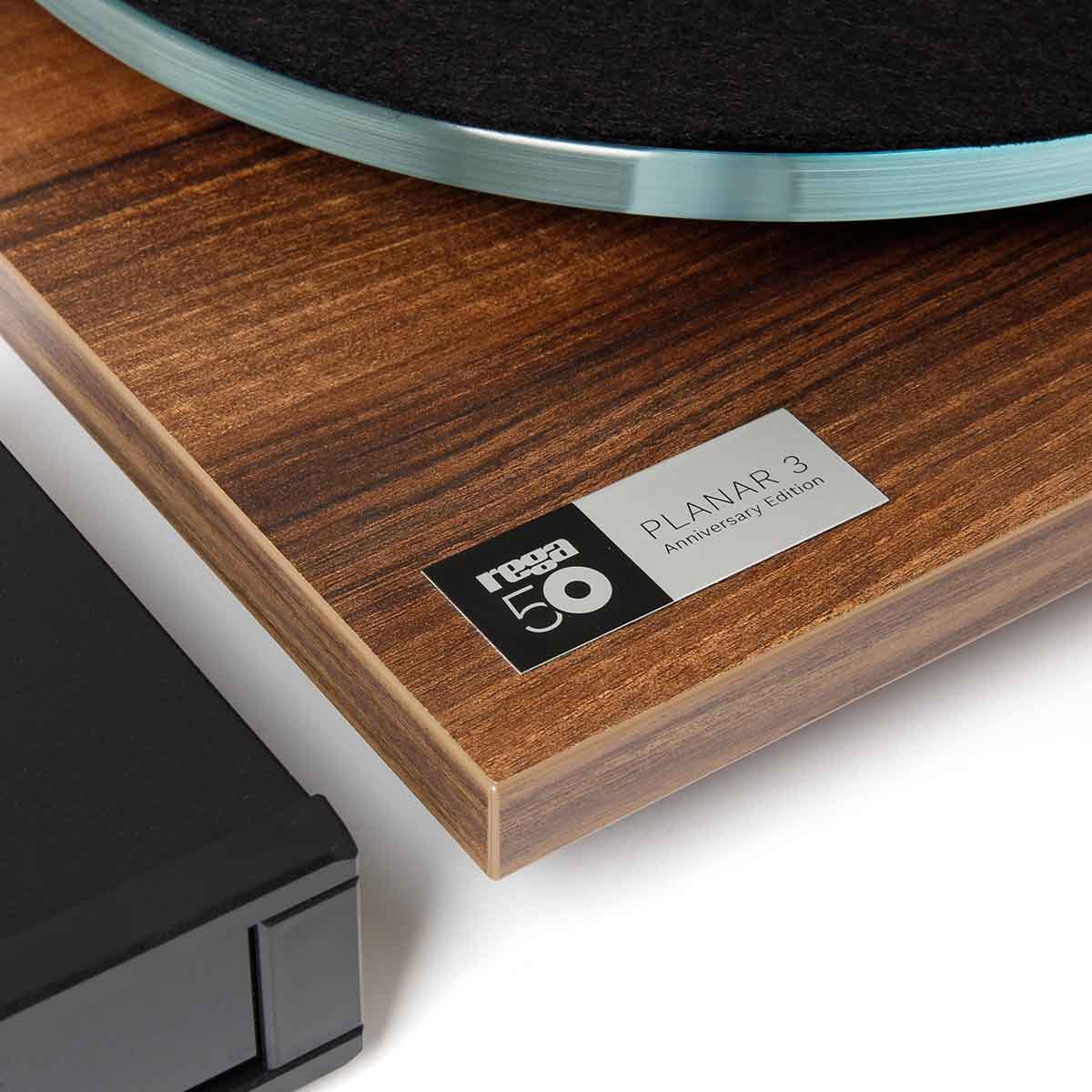 Rega Planar 3 50th Anniversary Edition Turntable - Walnut close-up of 50th anniversary badge next to Neo PSU