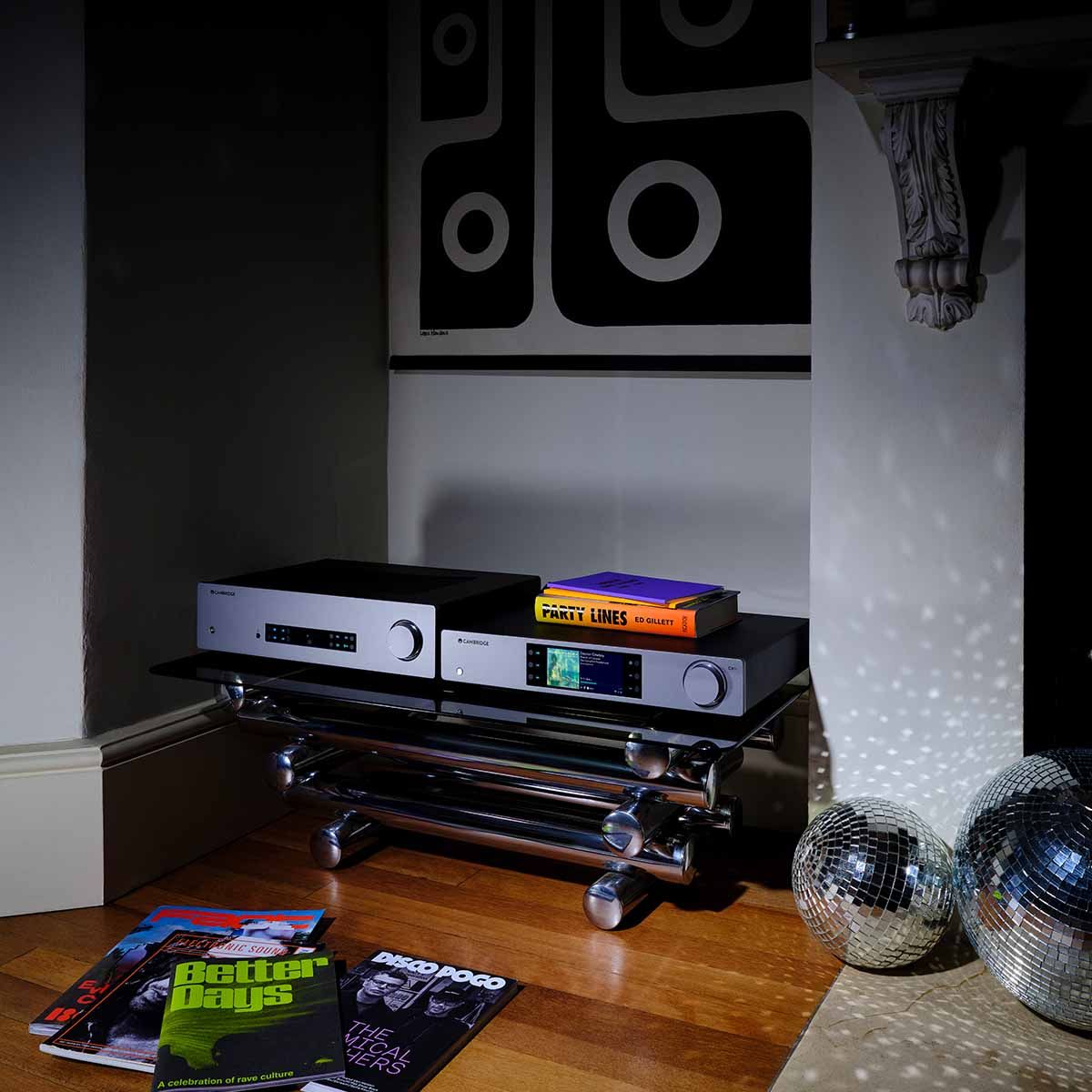 Cambridge CXN100 Network Player - Lunar Grey next to Cambridge integrated amp on small console table