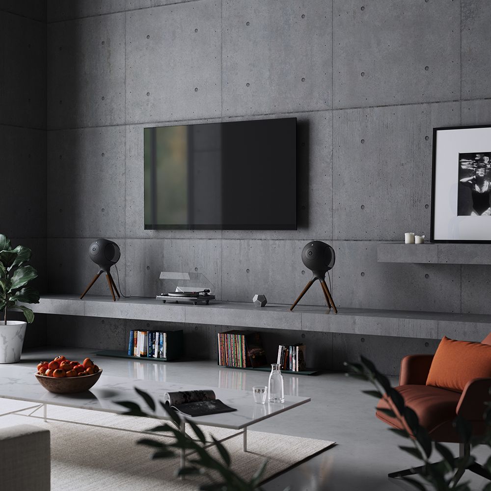 Devialet Phantom I 108dB Wireless Speaker, Dark Chrome, in dark-colored living room with a television and turntable
