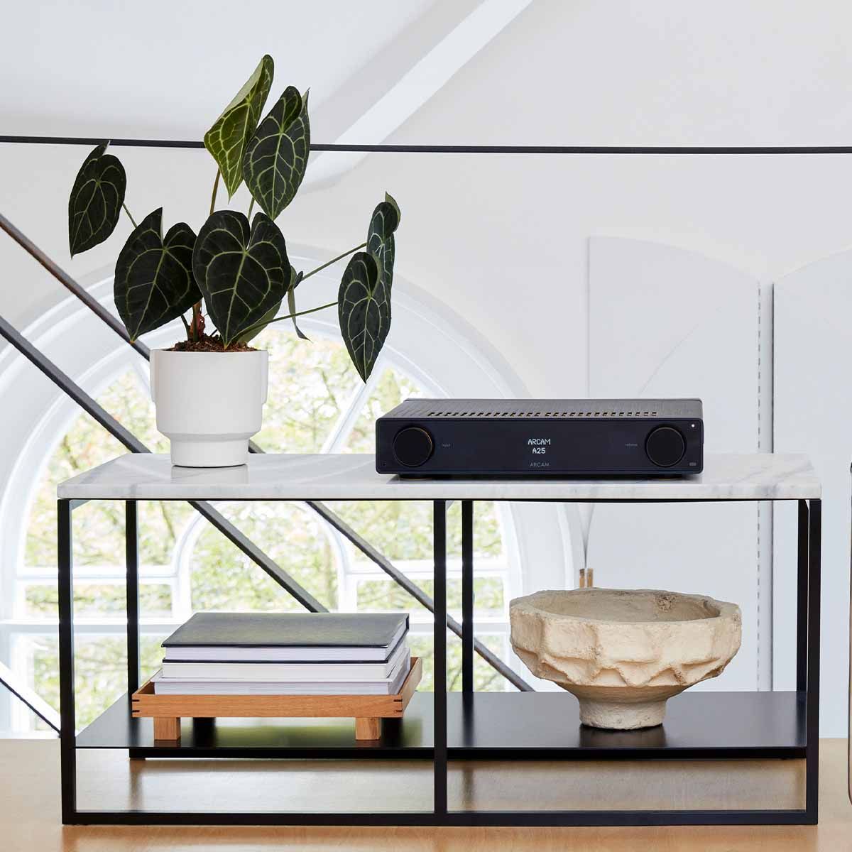 Arcam A25 Integrated Class G Amplifier on table in modern living room
