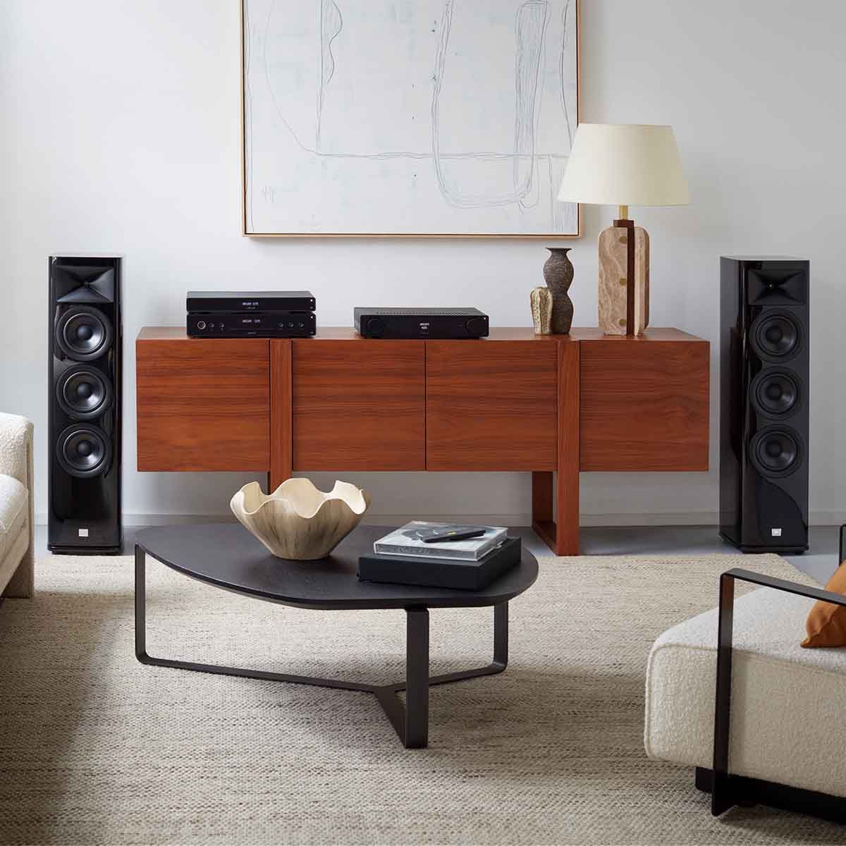 Arcam A25 Integrated Class G Amplifier on credenza with JBL HDI tower speakers