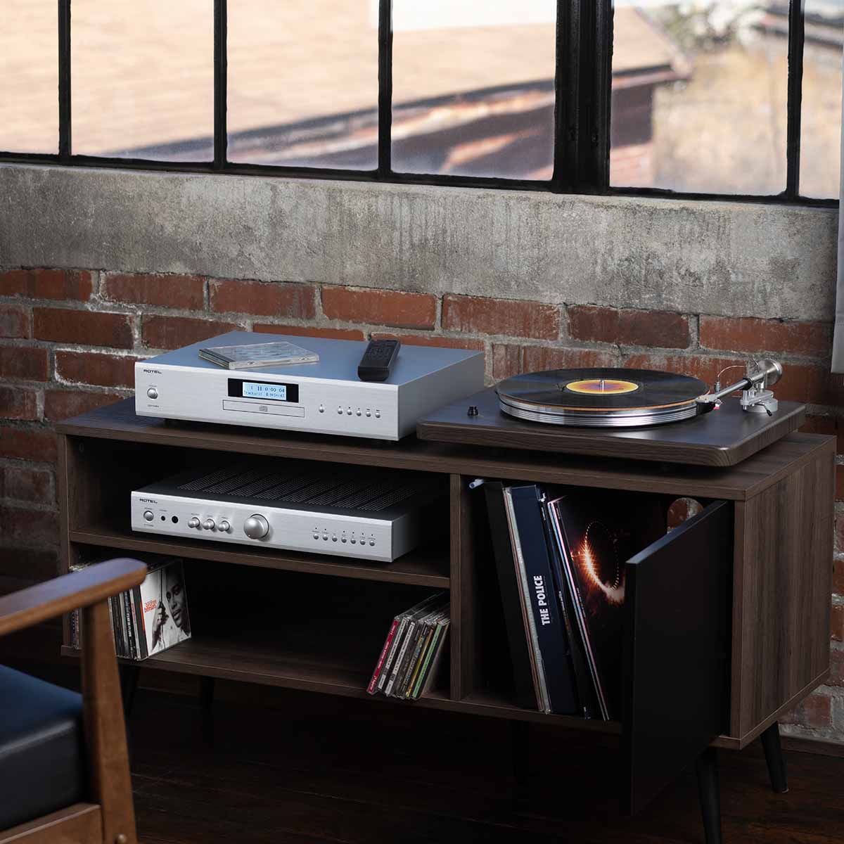 Rotel A11 MKII Integrated Amplifier silver on stand next to turntable