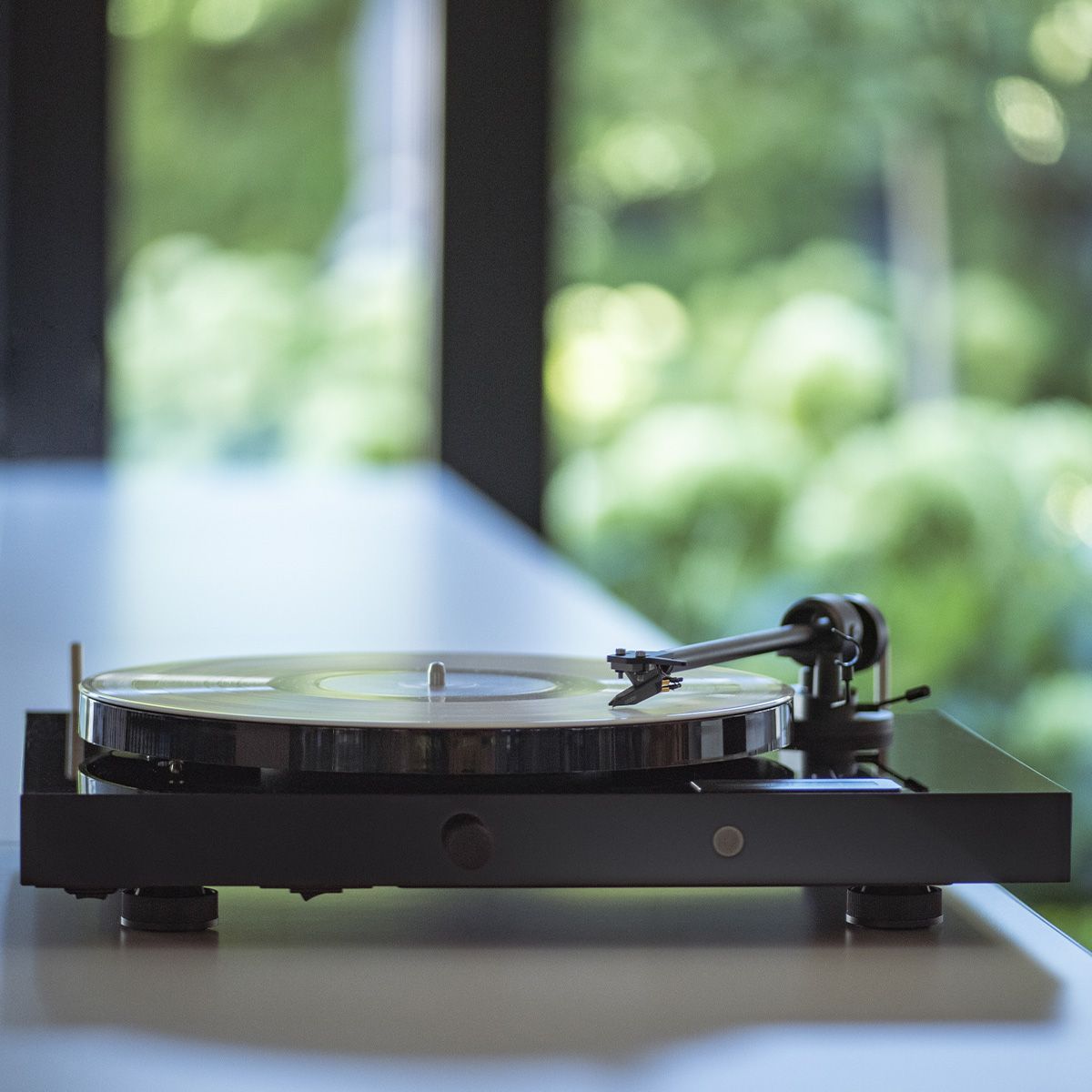 Pro-Ject Juke Box E1 Turntable in black sitting on a table