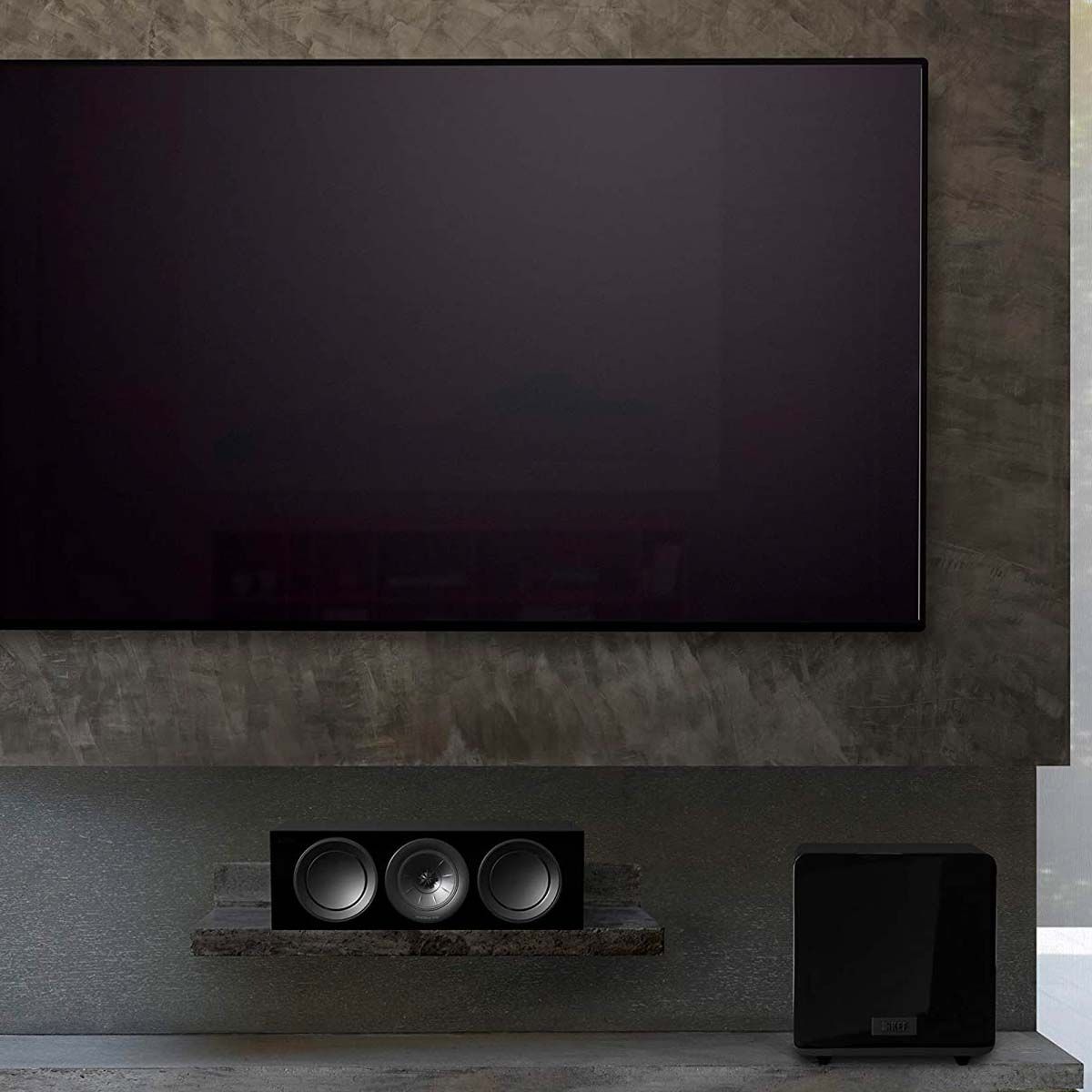 KEF KF92 1000W Dual 9 Inch Force Canceling with iBX - Gloss Black - Each - in room with TV and center channel speaker