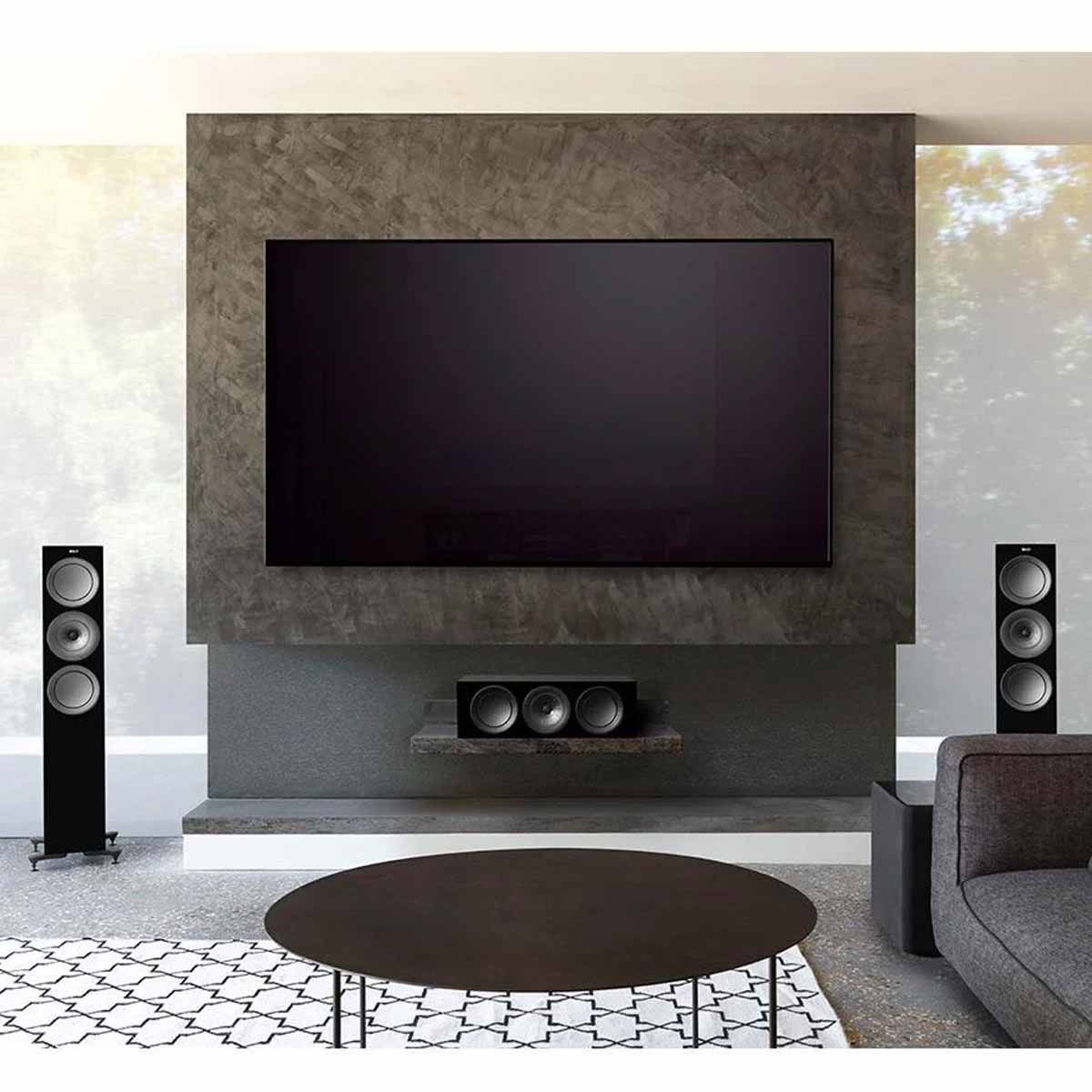 KEF R Series front stage with TV mounted on stone wall
