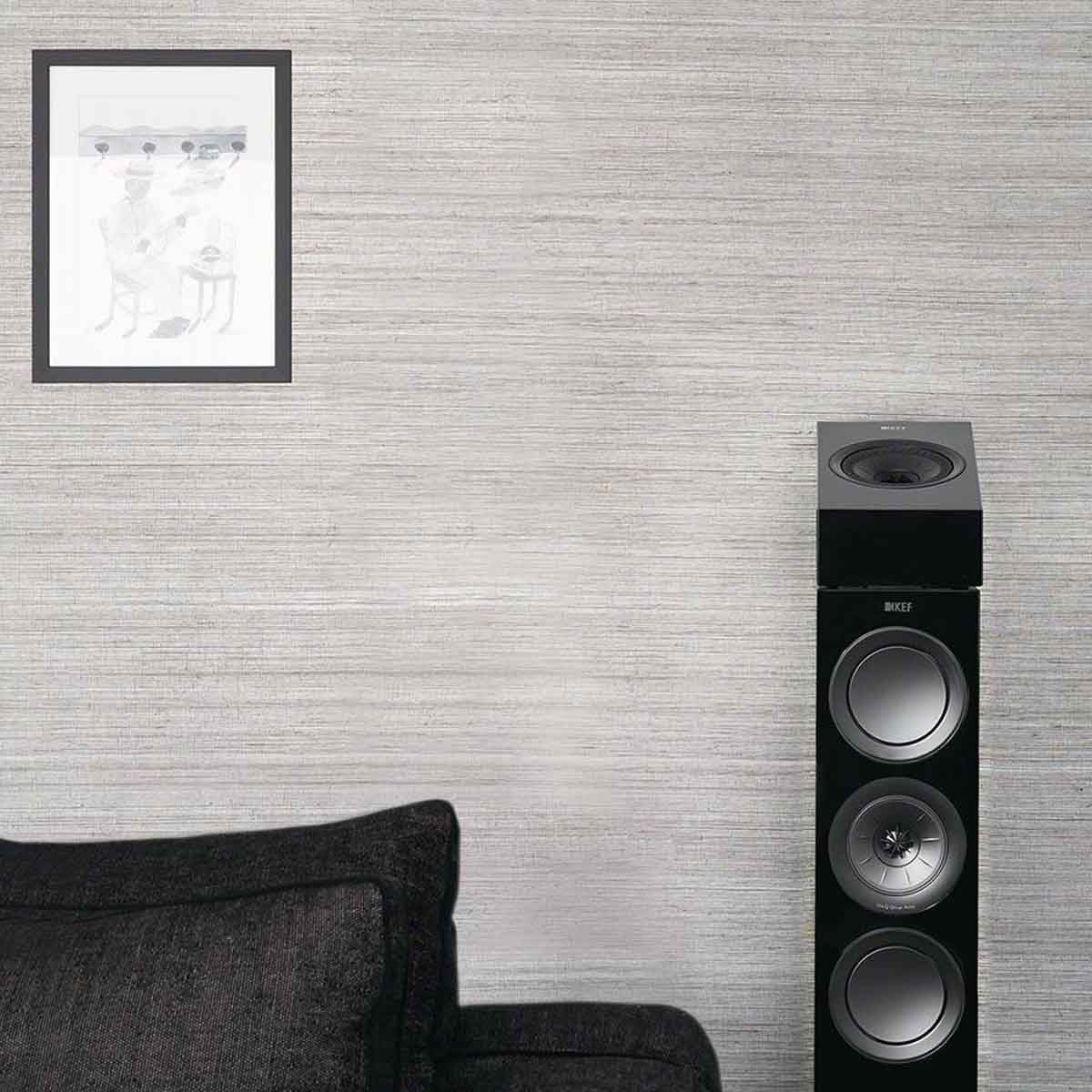 KEF R8a Dolby Atmos Module Surround Speakers - on top of black KEF floorstanding speaker