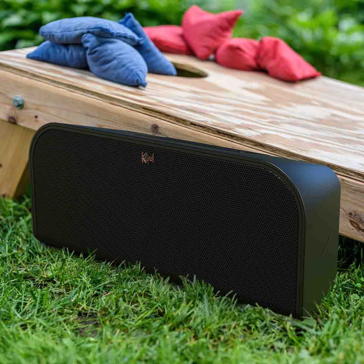 Klipsch Groove XXL Portable Bluetooth Wireless Speaker - Black - on grass next to cornhole board