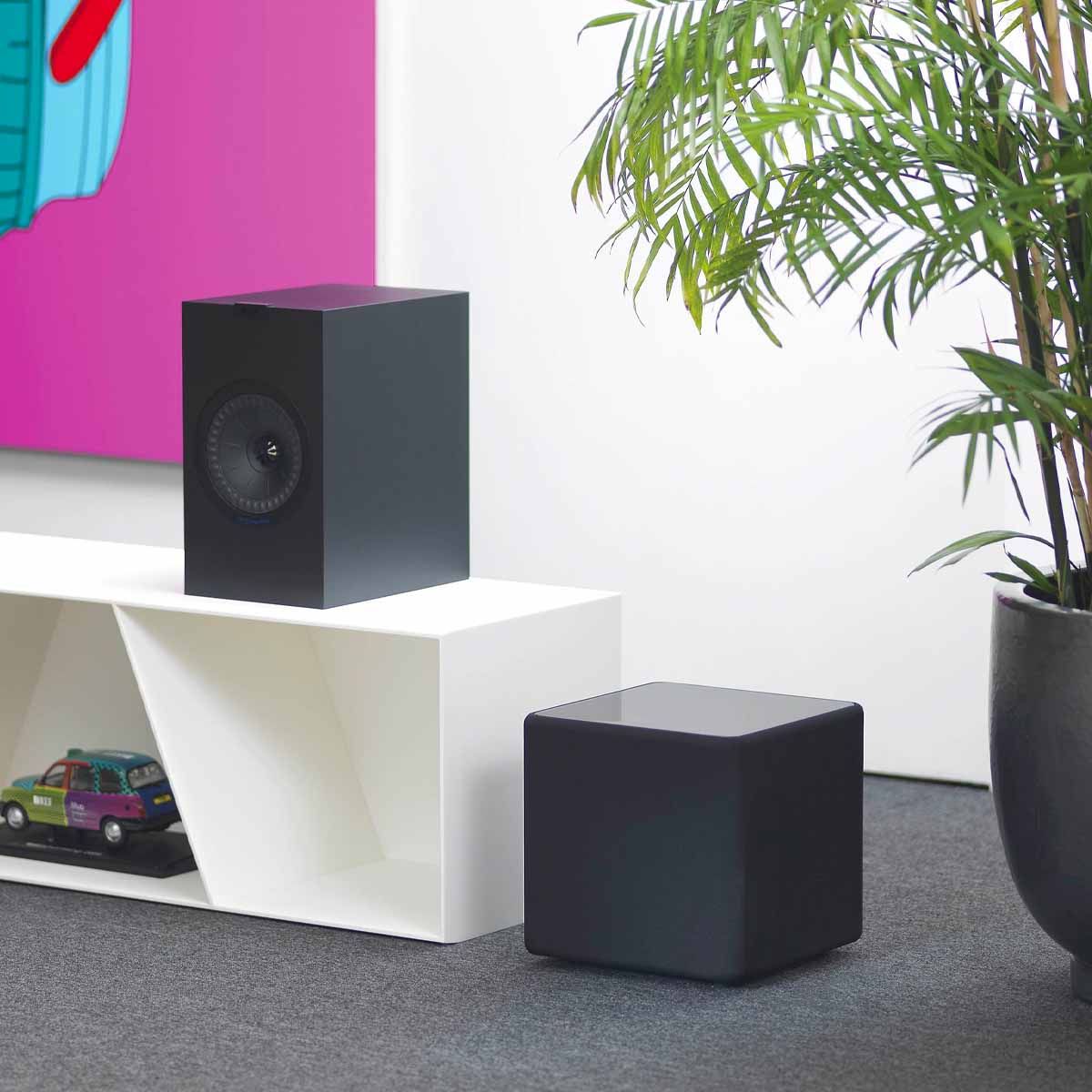 KEF KUBE8b 8-inch Bass Driver Active Subwoofer - Gloss Black - Each - sitting on floor next to media cabinet