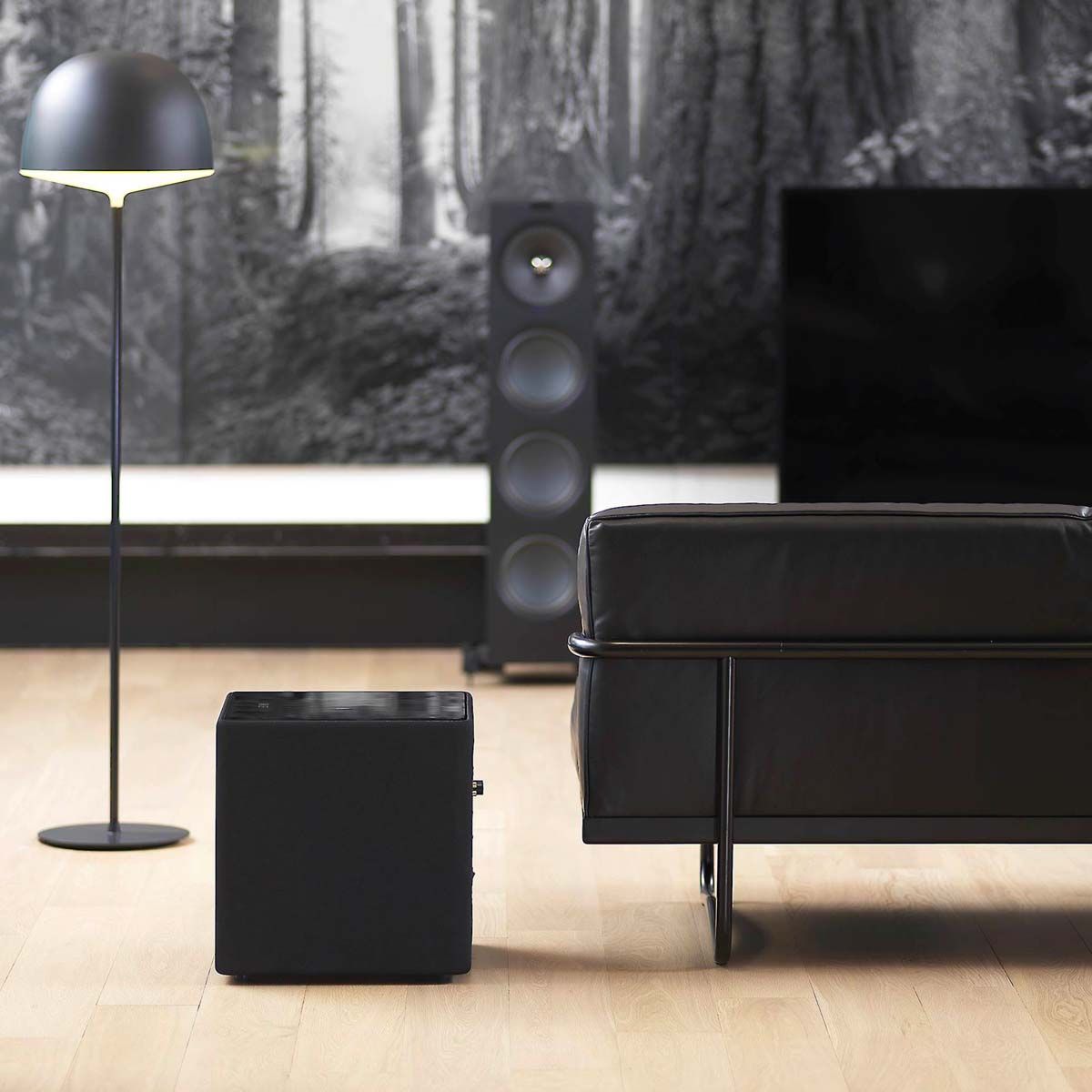 KEF KUBE12b 12-inch Bass Driver Active Subwoofer - Gloss Black - Each - on floor next to couch