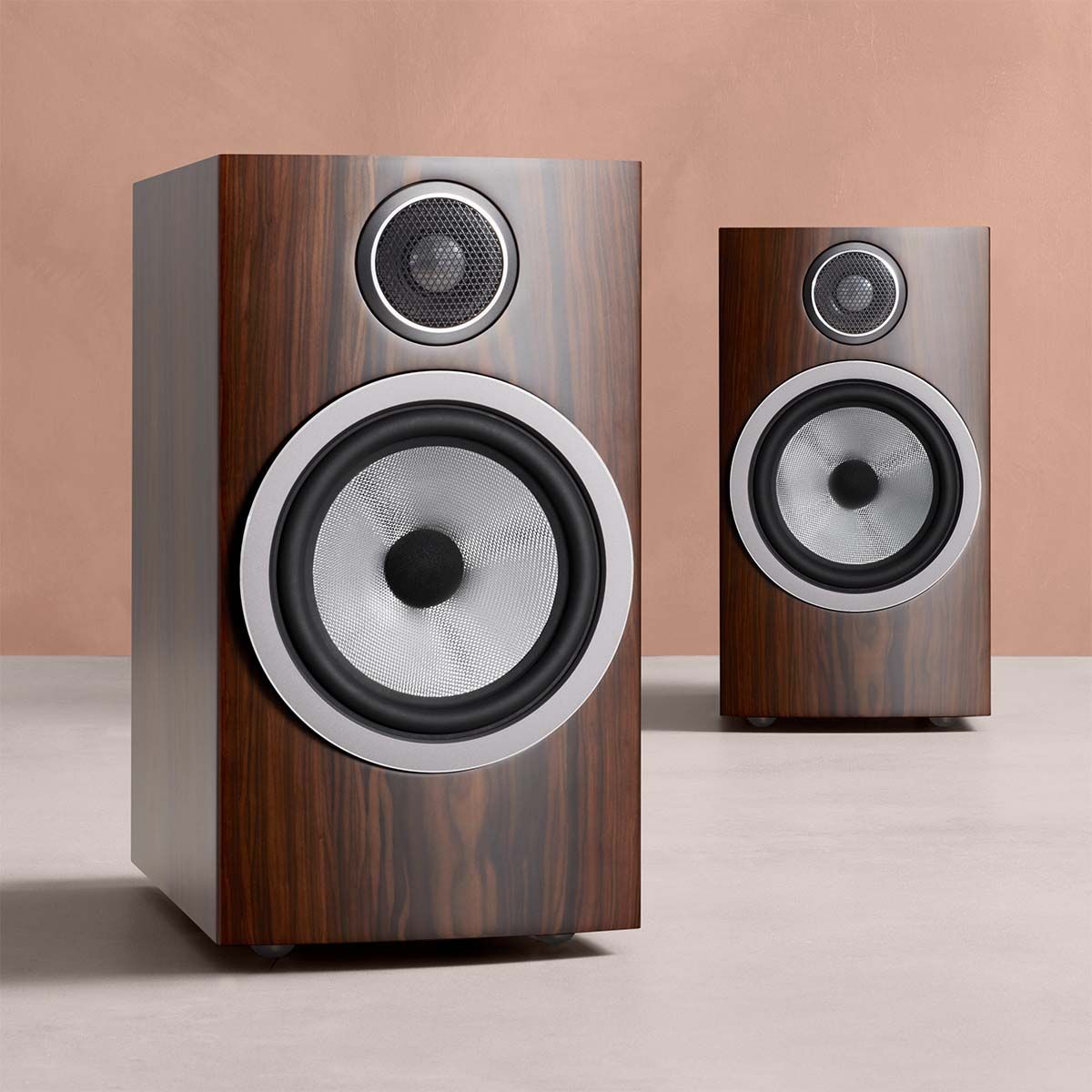 Bowers & Wilkins 706 S3 2-Way Stand Mount Bookshelf Loudspeakers in mocha on table with orange background