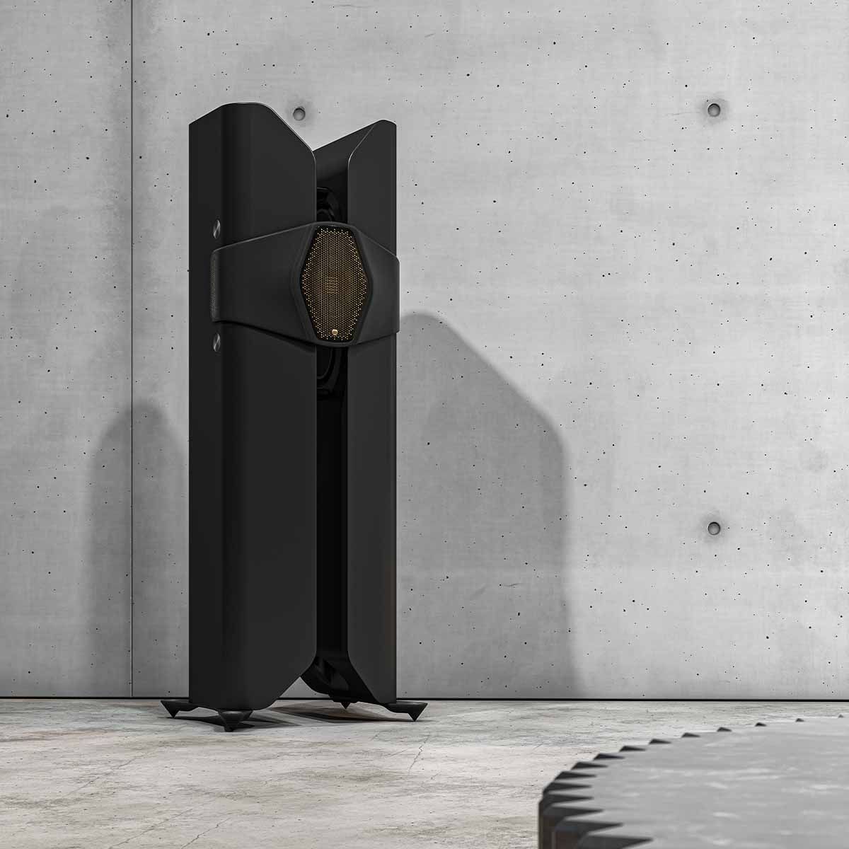 Monitor Audio Hyphn Reference Floorstanding Loudspeaker - front view of black speaker against concrete wall