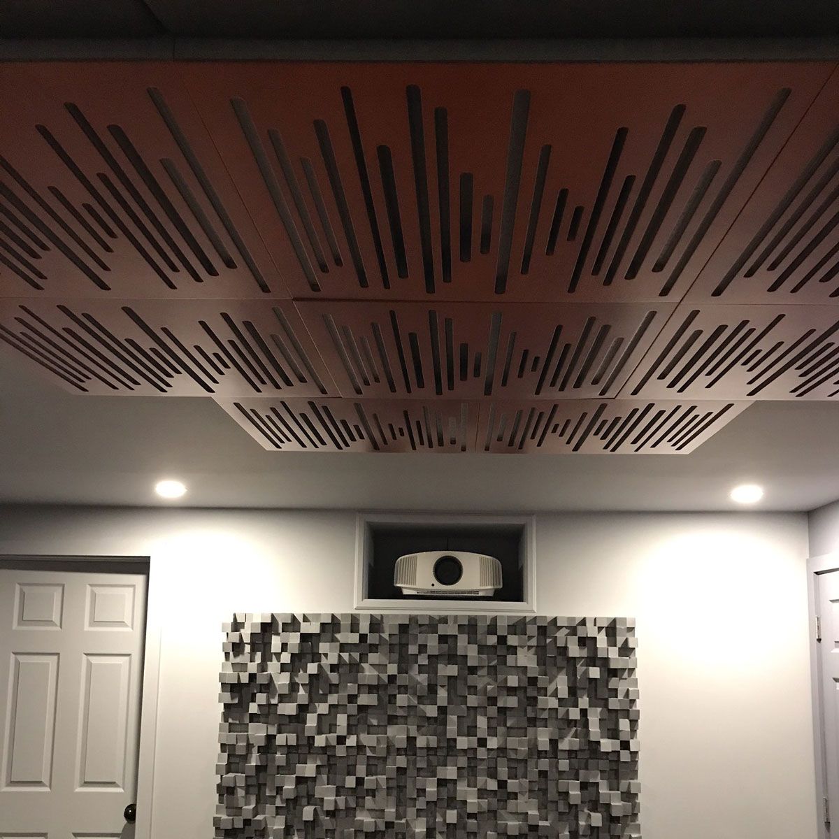 Vicoustic Wavewood Ultra Diffuser, set of eight, arranged in a pattern on a ceiling with a white projector and other acoustic treatments