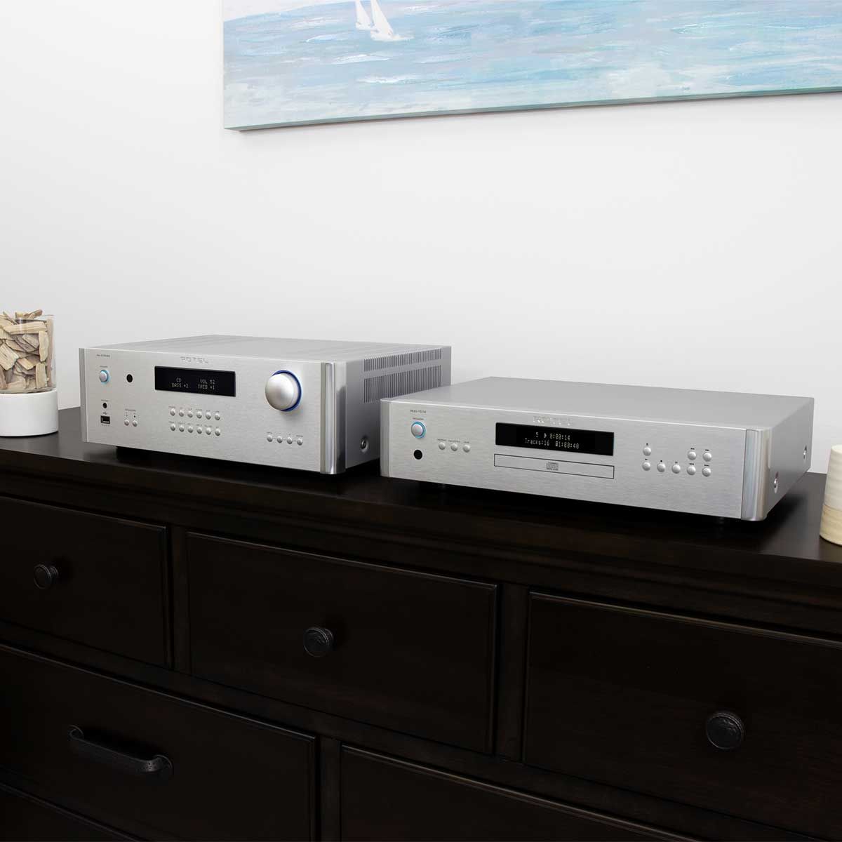 Rotel RA-1572 MKII Integrated Amplifier, Silver, set up on a media console beside a silver Rotel CD player
