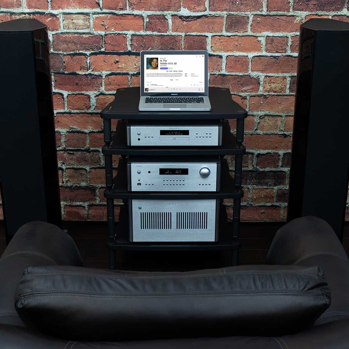 Rotel RC-1590 MKII Stereo Preamplifier, Silver, set up in an audio rack between two tower speakers