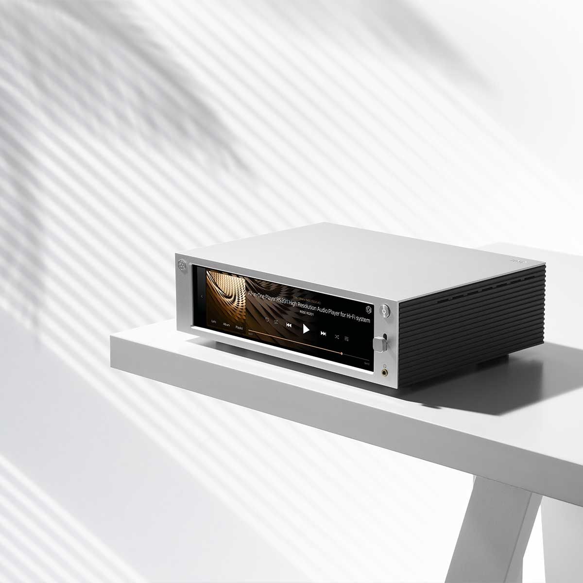 Side angled view of the HiFi Rose RS201E Integrated Amplifier and Network Streamer sitting on top of a tabletop.
