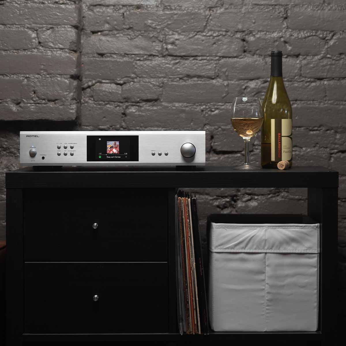 Rotel S14 Integrated Network Streamer - silver on hutch with wine glass