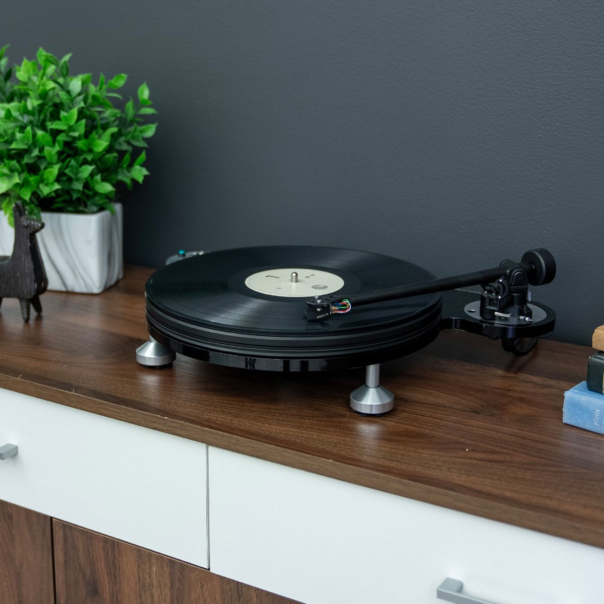 Michell TecnoDec Turntable on a wooden console cabinet