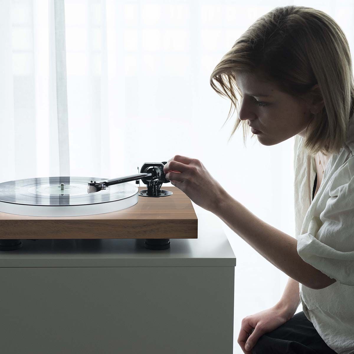 Pro-Ject X1B True Balanced Turntable - on table with female lowering tonearm