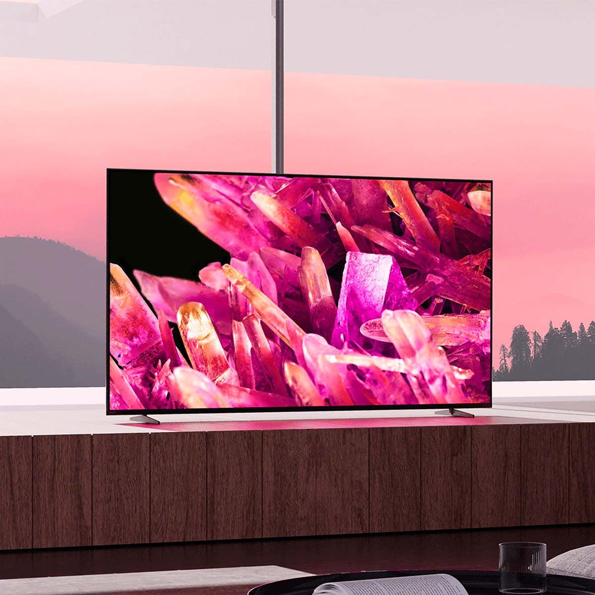 Sony BRAVIA XR X90K 4K Television, on a media stand in front of a sunset