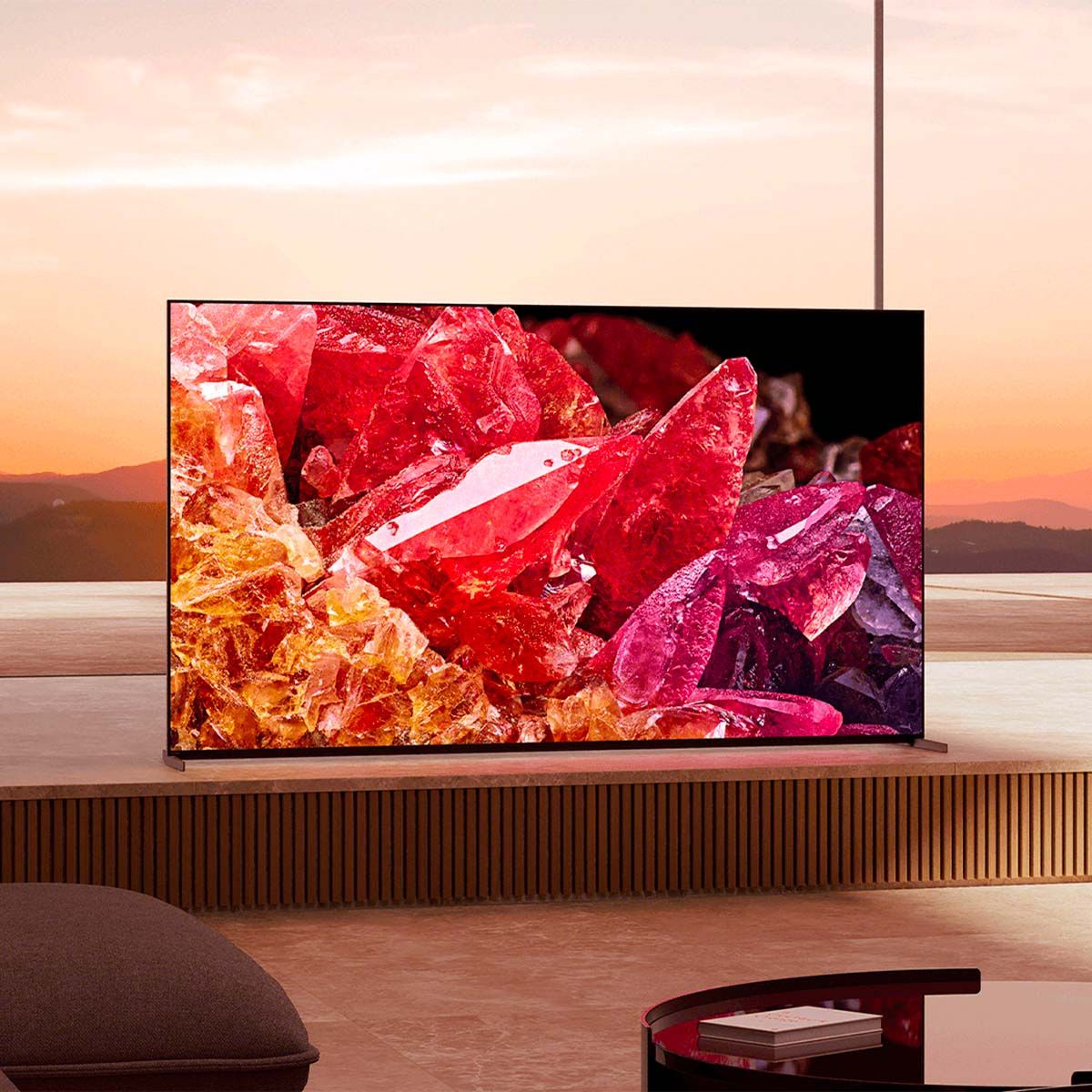 Sony BRAVIA XR X95K 4K LED TV, on a media stand in front of a sunset