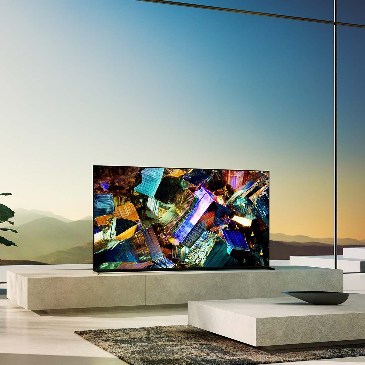 Sony BRAVIA XR Z9K 8K LED HDR Television, on a media stand in front of a large window with a sunset view