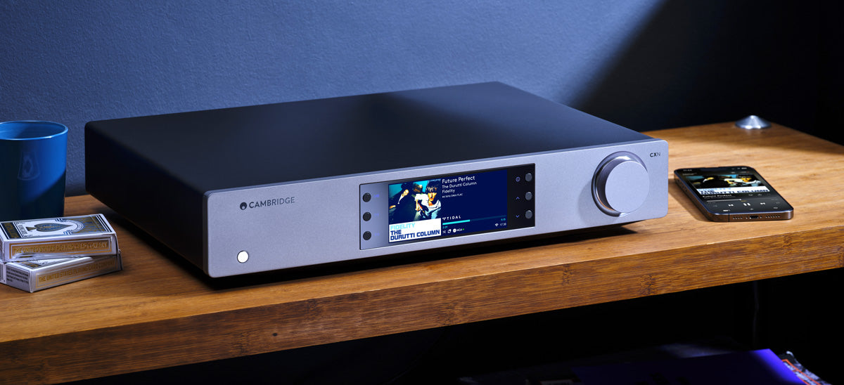 Cambridge Audio CXN100 Network Player on a shelf next to a smart phone