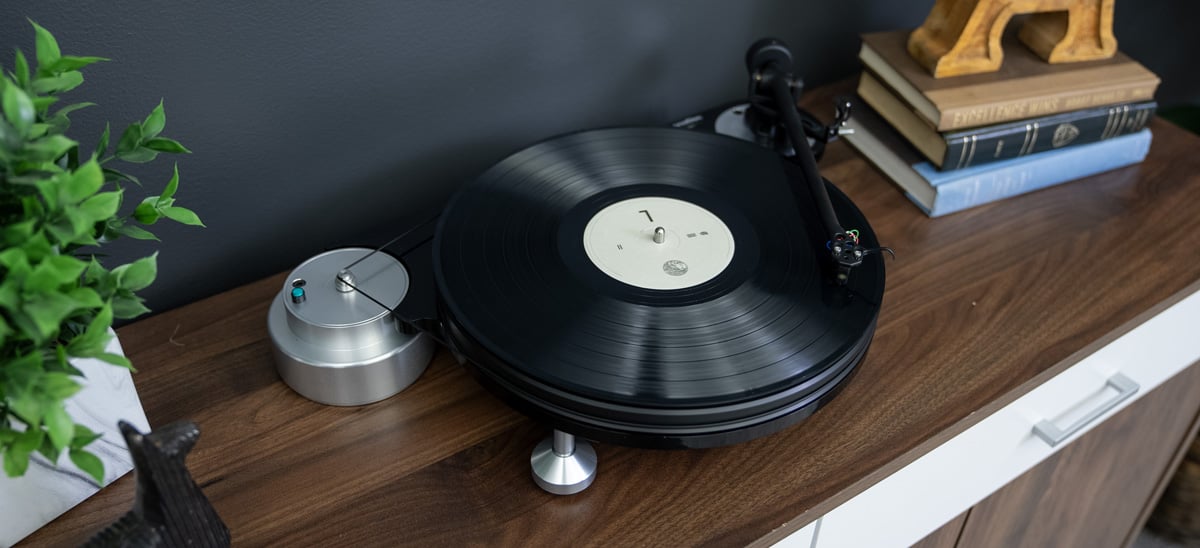 Michell TecnoDec Turntable on a wood console cabinet