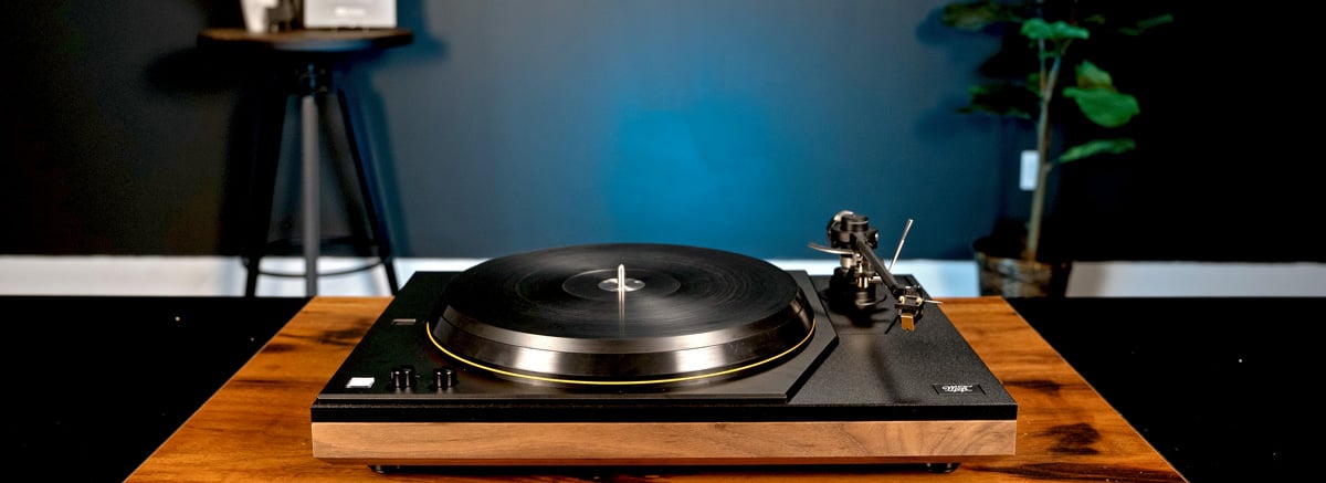 MoFi Masterdeck turntable on a table in front of a blue wall