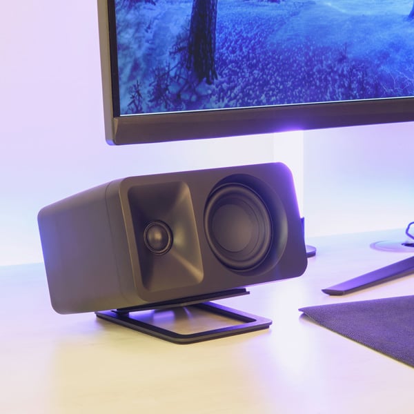 Close up of Kanto ORA desktop speaker with gaming set up