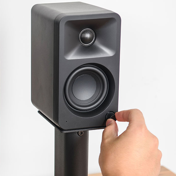 Hand turning knob on the front of a Kanto ORA desktop speaker