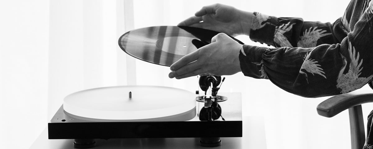 Black and white photo of vinyl being put on a Pro-Ject X1B Turntable